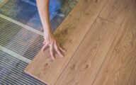 Laminate flooring being installed over electric underfloor heating